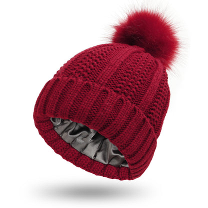 Fabulous Fur Fiesta: Stylish Stretchy Satin Hats with Skull Knit and Faux Fur Pom Pom for Women